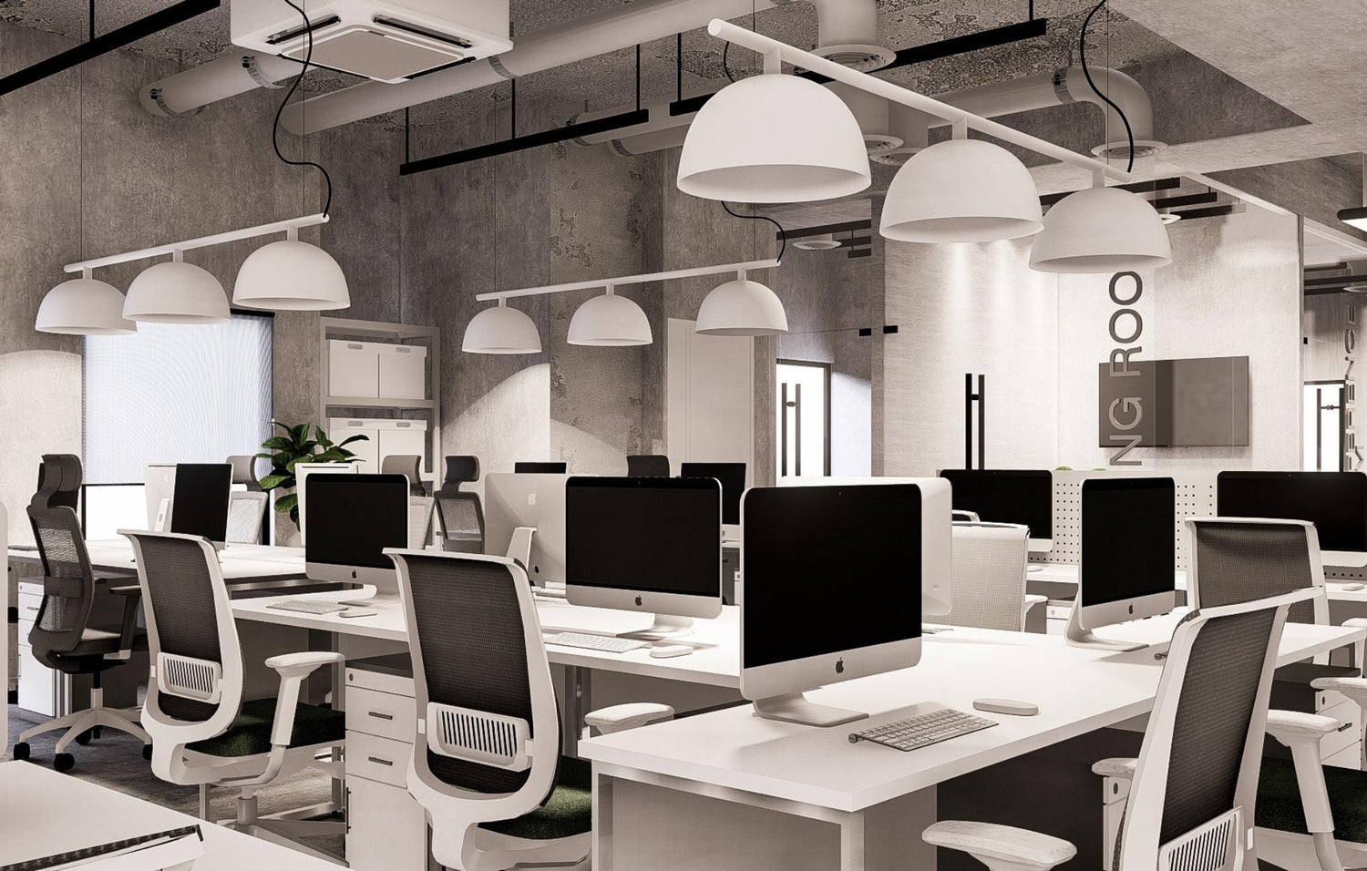 Modern office interior with computers, desks, and hanging lamps.