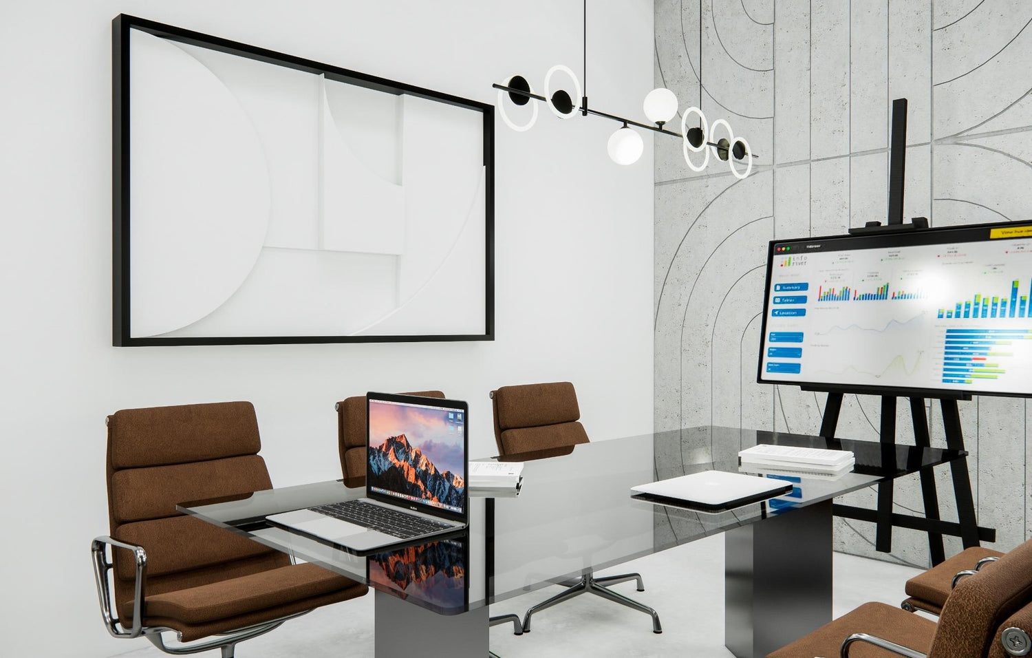 Modern office with laptops, a large monitor displaying graphs, and abstract wall art.