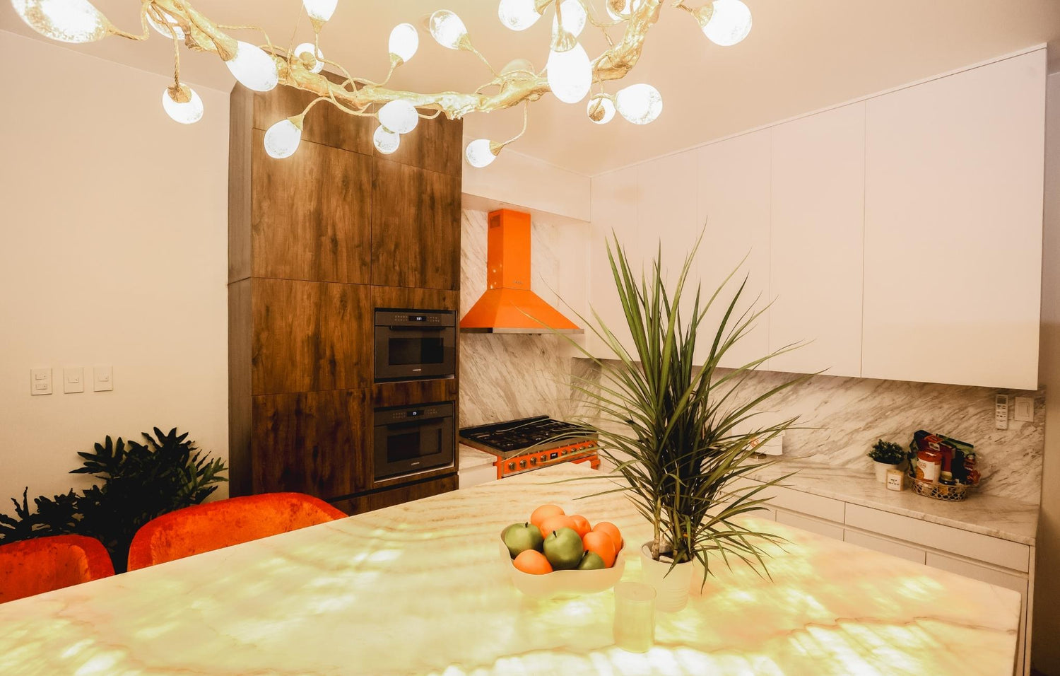 A stylish kitchen showcasing lively orange and white accents, adding a pop of color to the culinary environment.