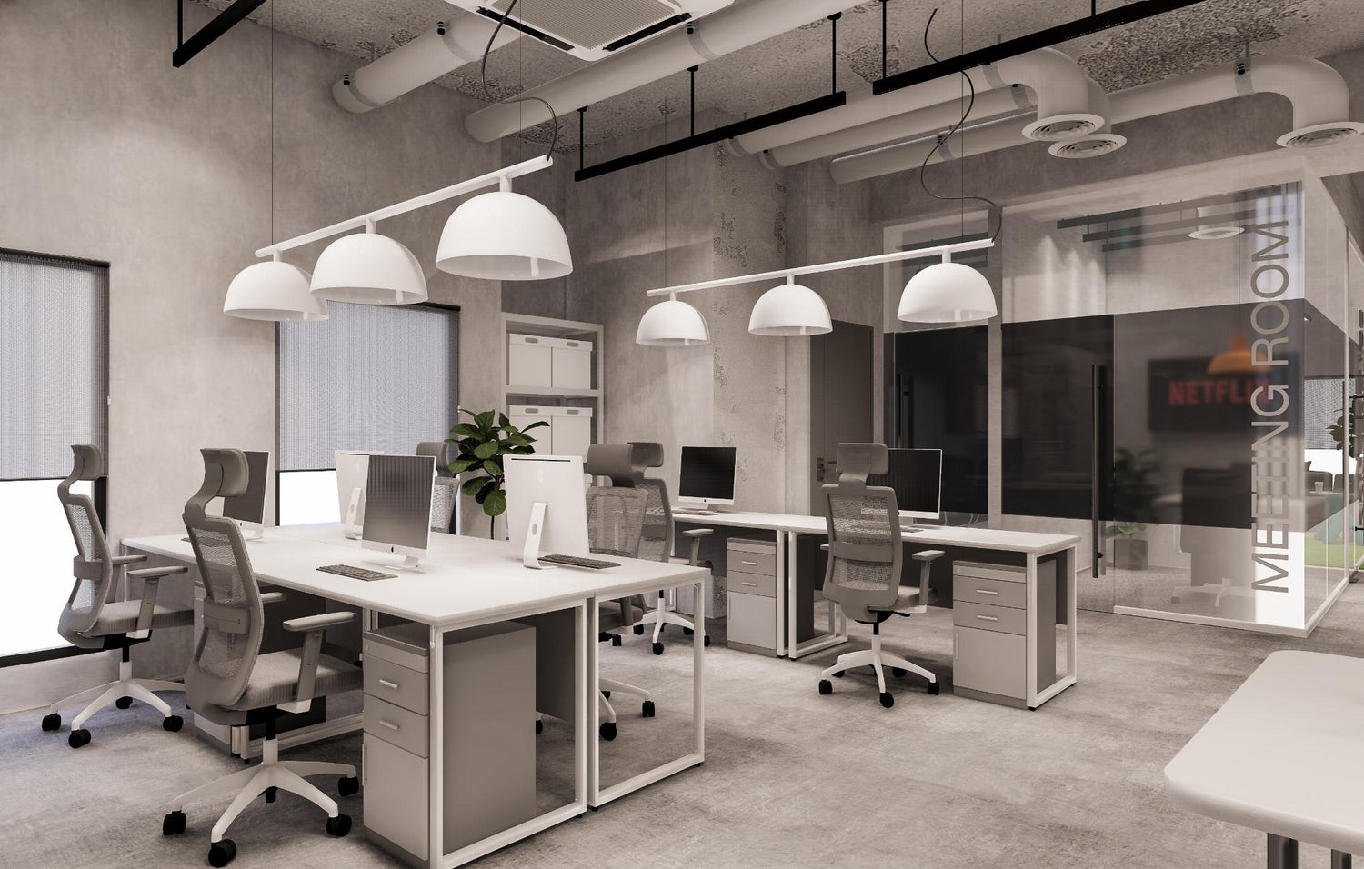 Modern office interior with desks, chairs, and pendant lights, with a meeting room in the background.