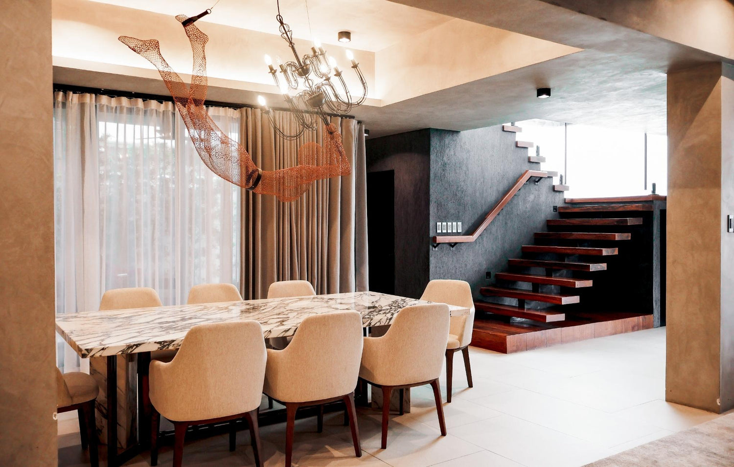  A cozy dining room featuring a wooden table surrounded by elegant chairs, perfect for family meals and gatherings.