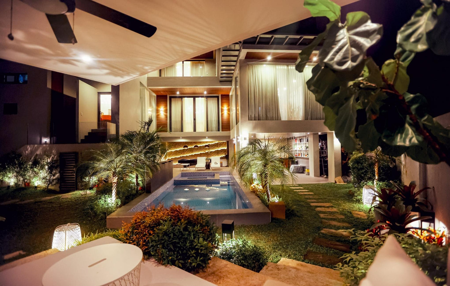 A contemporary house with a beautiful pool and vibrant landscaping, perfect for relaxation and outdoor enjoyment.
