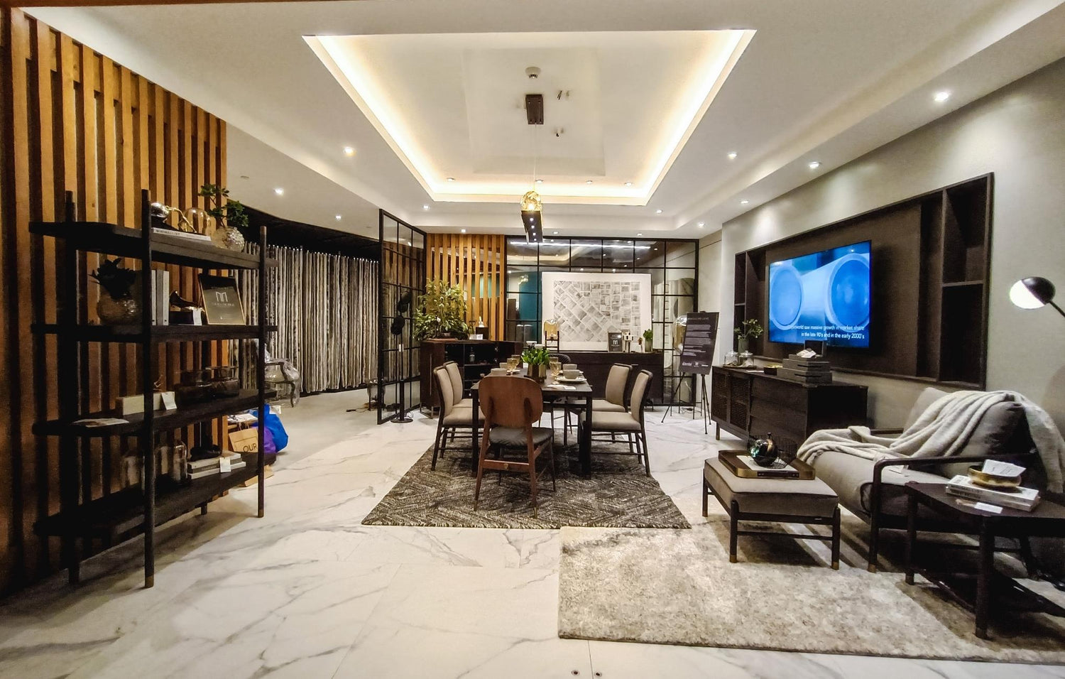  A cozy living room featuring a television and elegant marble flooring, creating a stylish and inviting atmosphere.
