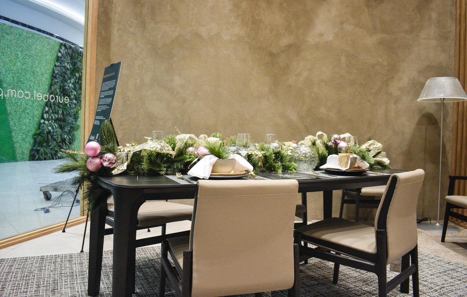  A charming table surrounded by four chairs, featuring a lovely flower arrangement that adds a touch of elegance.