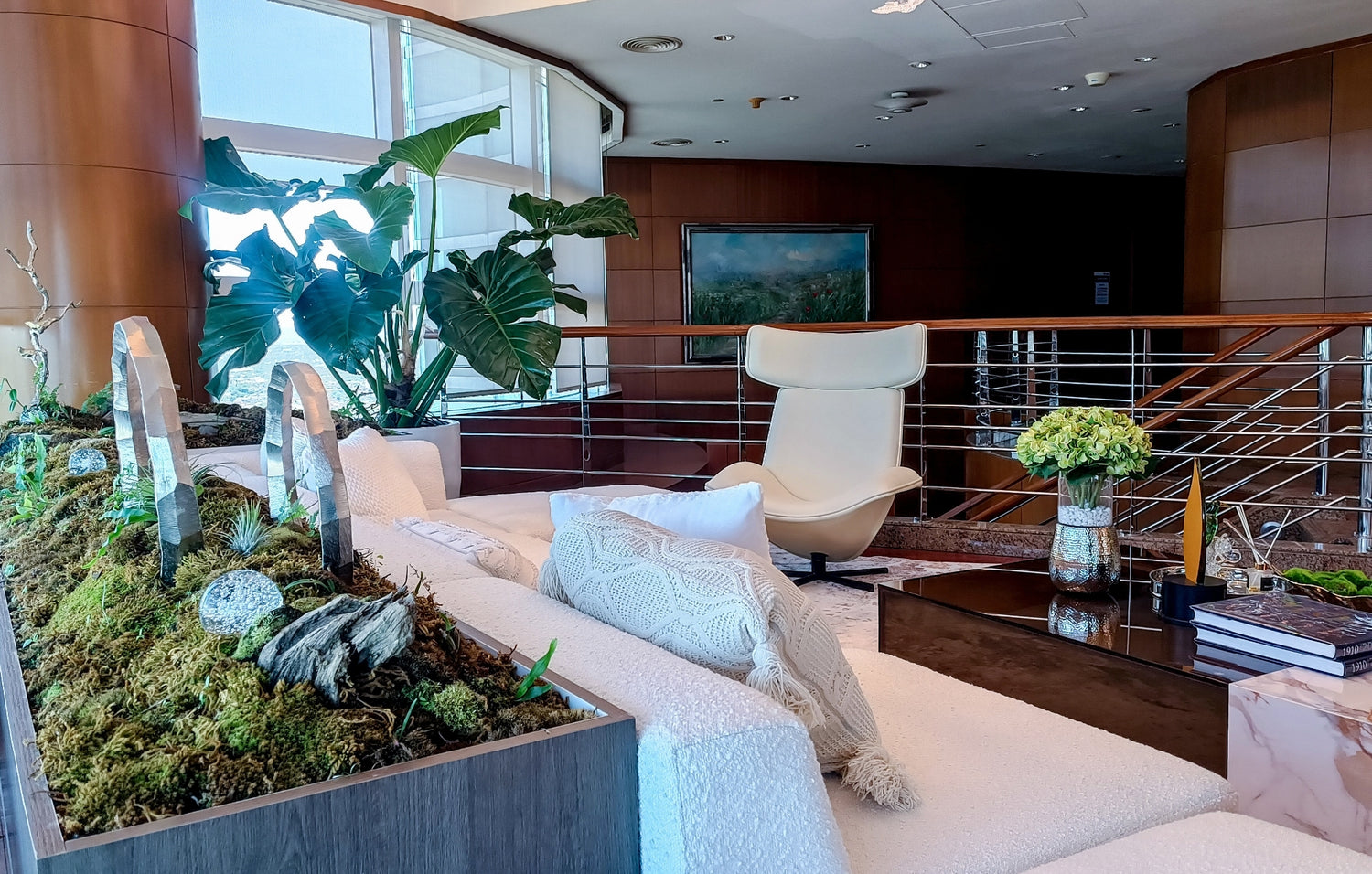 Modern office lobby with plush seating, indoor greenery, and a crystal decoration.