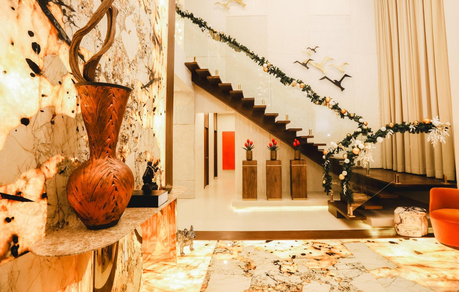  A welcoming living room with a staircase and a beautiful vase, perfect for relaxation and gatherings.