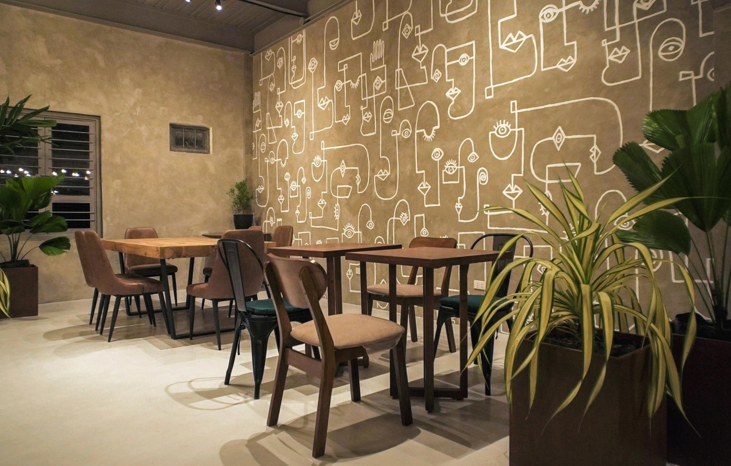 Modern dining room with artistic doodle wall mural and wooden furniture.
