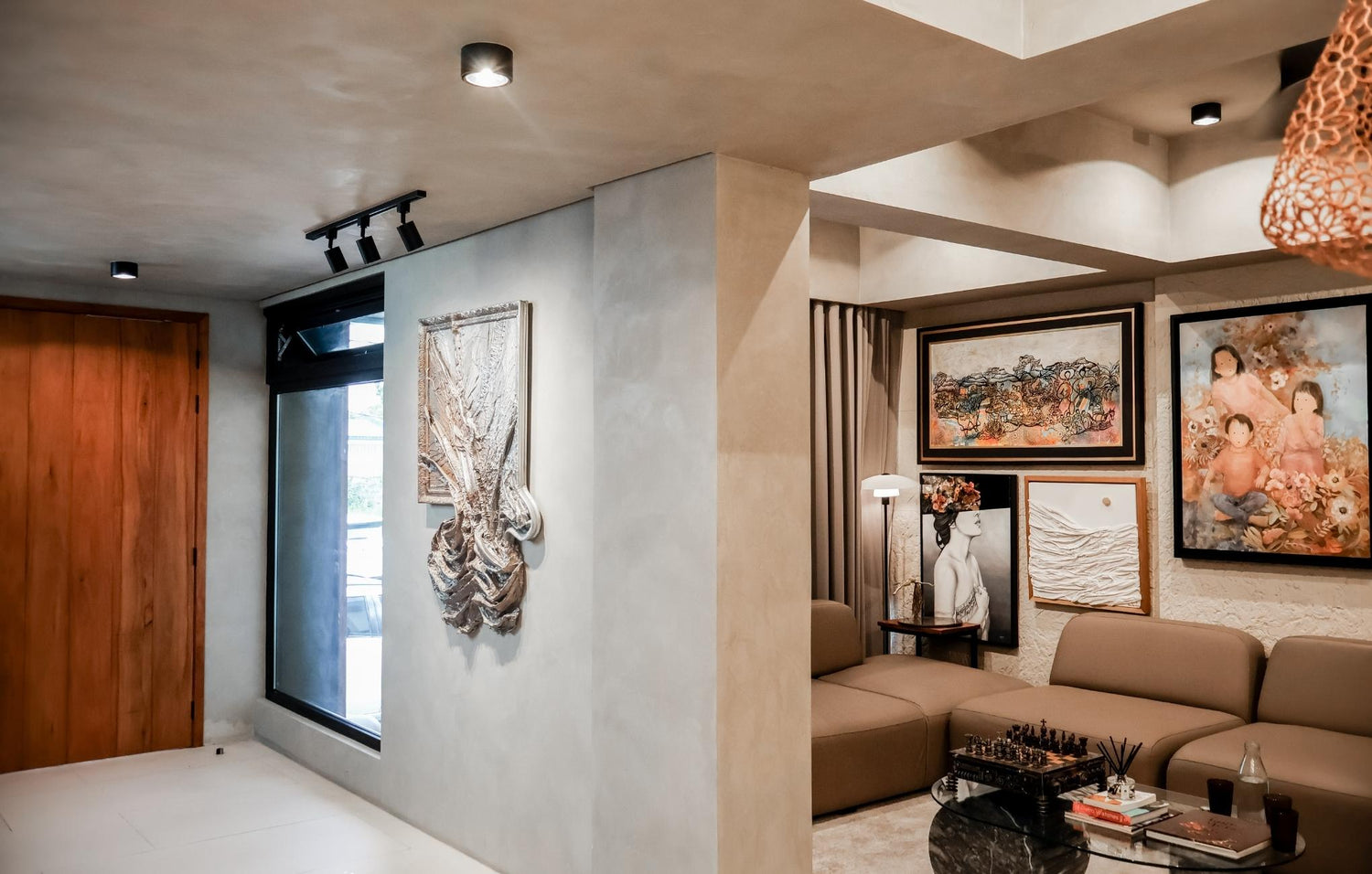 Stylish living room showcasing a soft couch and vibrant artwork hanging on the walls.