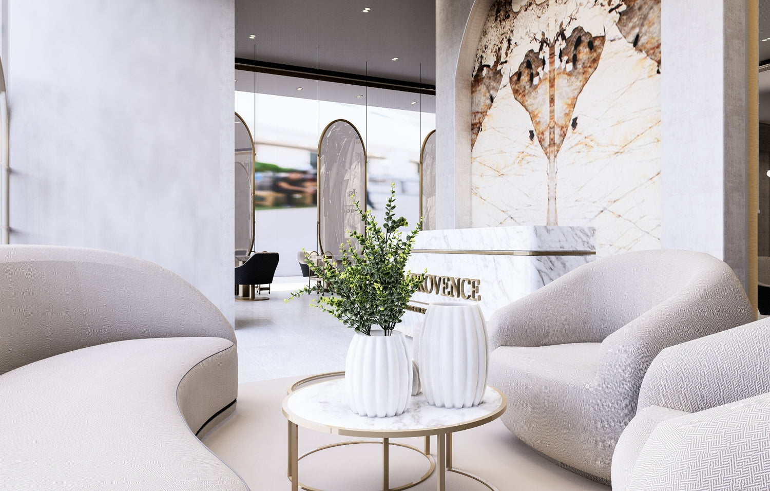 Modern lobby with curved sofas, marble tables, and a decorative plant.