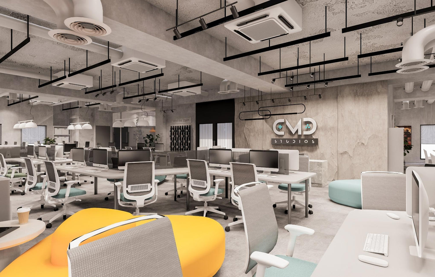 Modern office space with desks, chairs, and decorative lighting, featuring a CMD Studios logo on the wall.