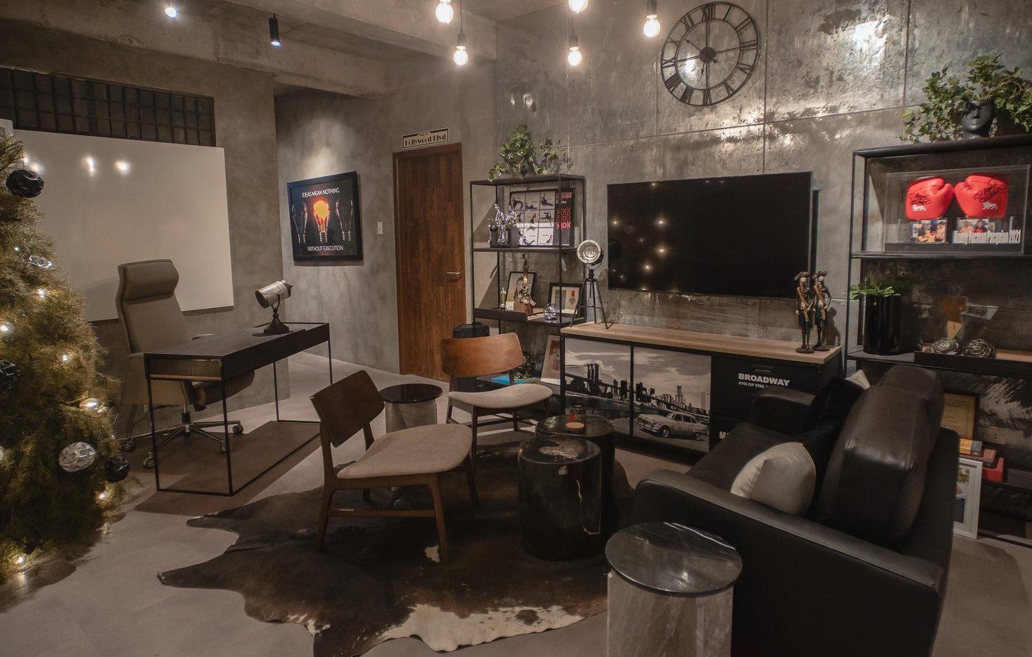 Industrial-styled living room with a TV, sofa, Christmas tree, and eclectic decor.