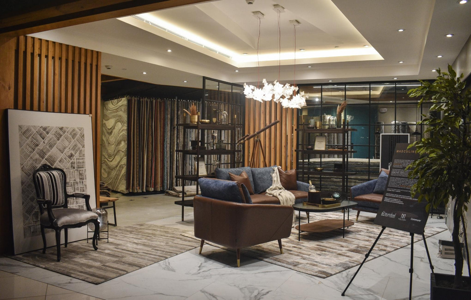 Modern interior design showroom with furniture, decor, and lighting.