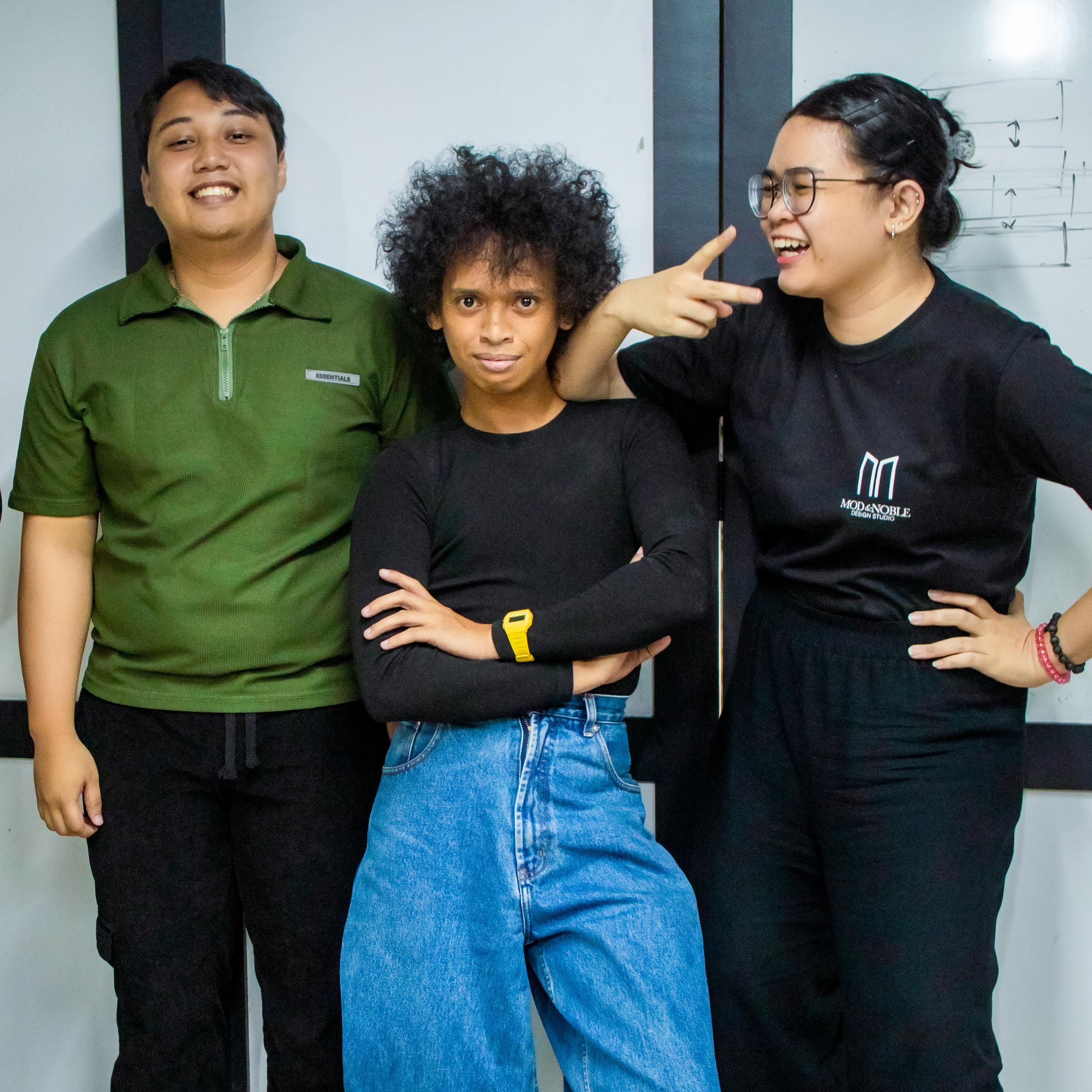 Smiling and posing for a fun group photo of Mod and Noble team members: Liam Nano (Procurement), Baks Fulo (Marketing), and Lizette Villareal (Jr. Interior Designer).