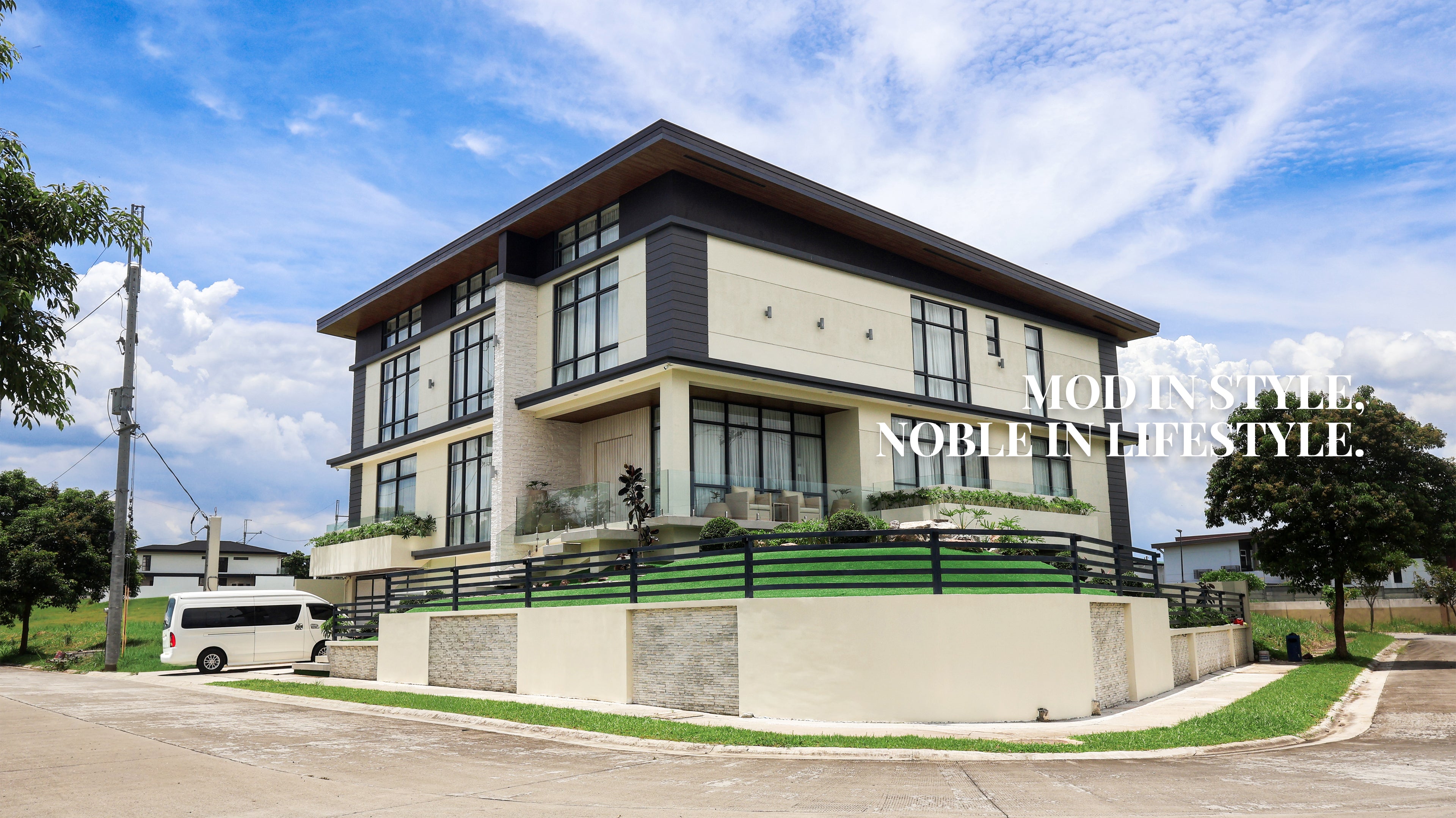 Contemporary two story residential house with modern facade, glass windows, and balcony design by Mod and Noble Design Studio