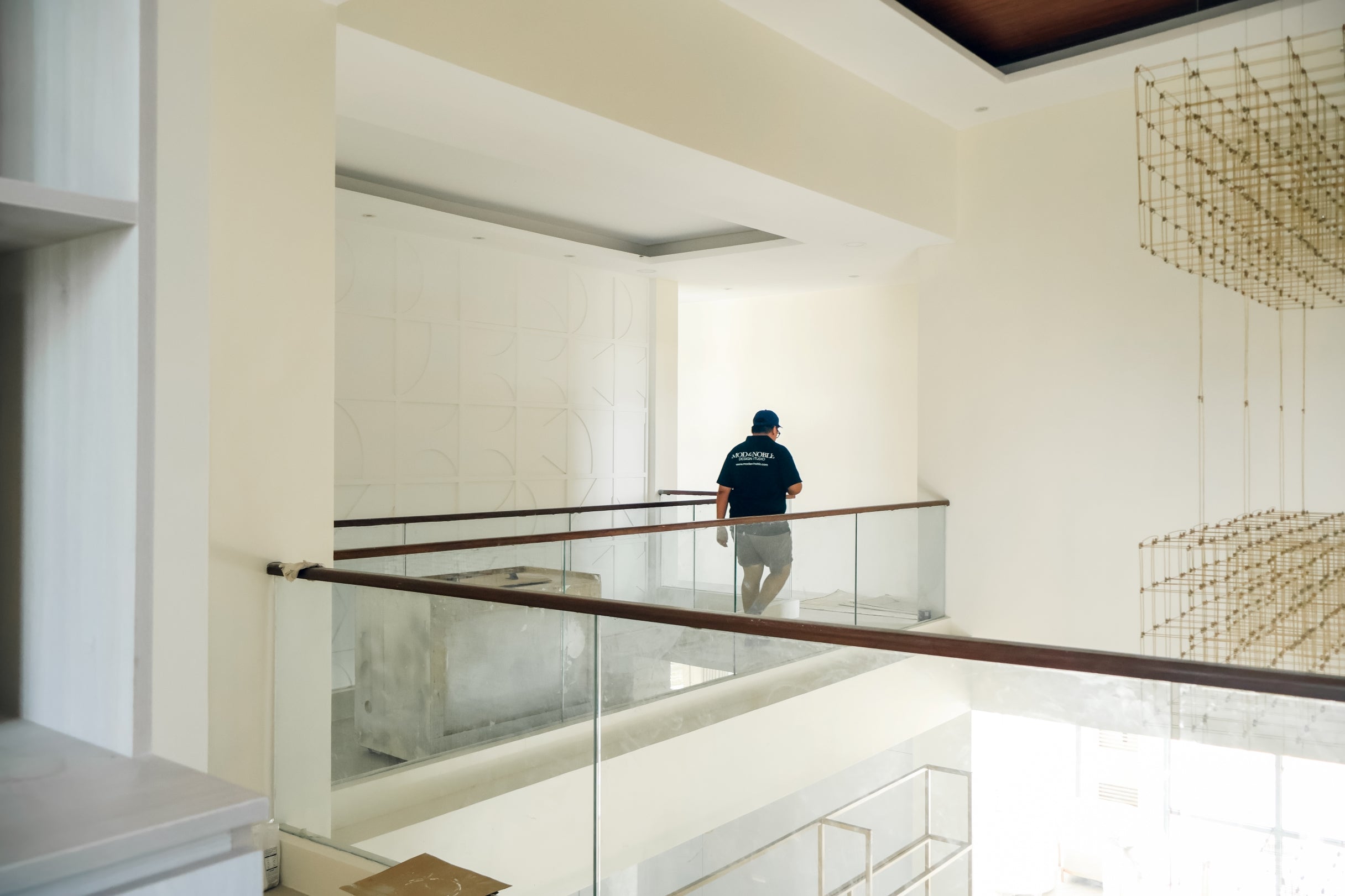 Roy Javier descends a staircase in a cozy home, showcasing a warm and inviting atmosphere.